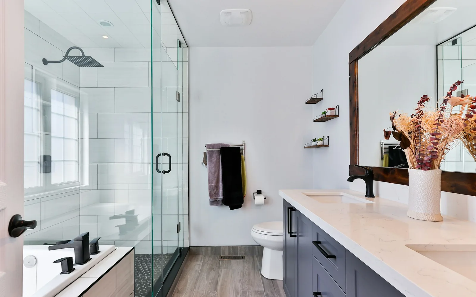 A modern shower with renter-friendly wall space